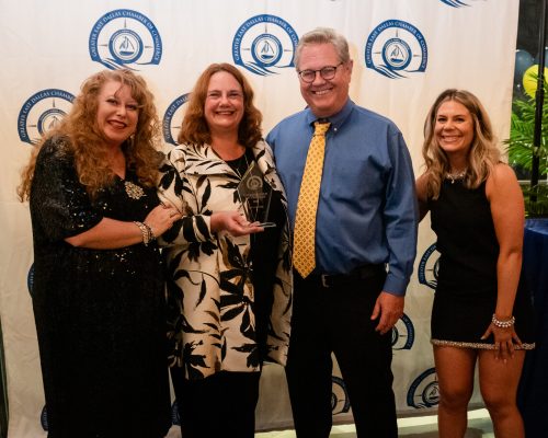 Greg and Gayle holding the award