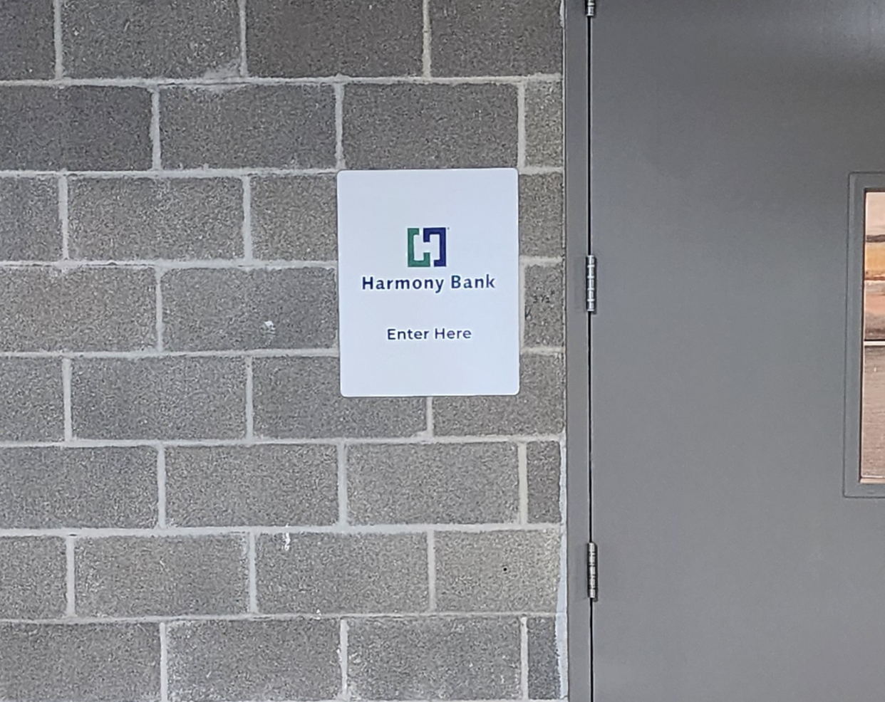 Directional Sign in a parking lot by It's A Good Sign for a Harmony bank installed in their garage area to provide directions to their clients